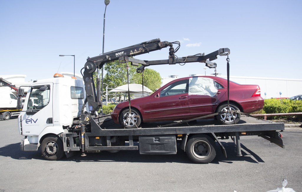 Old bangers . . . migrants slept in the cars at night 