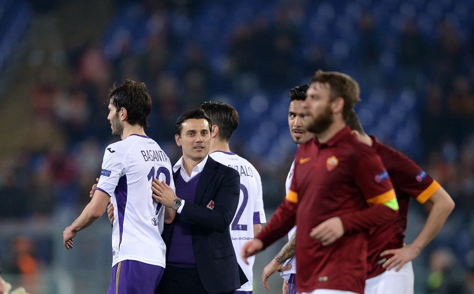 Fiorentina's coach Vincenzo Montella (C) congratulates defender from Argentina Jose Basanta (L) at the end of the Europa League Round of 16 second leg football match Roma vs Fiorentina on March 19, 2015 at the Olympic stadium in Rome. Fiorentina won 0-3. AFP PHOTO / FILIPPO MONTEFORTE (Photo credit should read FILIPPO MONTEFORTE/AFP/Getty Images)