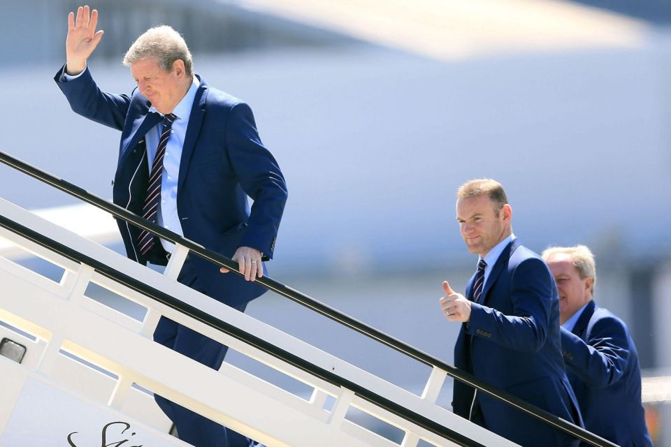 Hodgson is closely followed onto the plane by Wayne Rooney and Ray Lewington