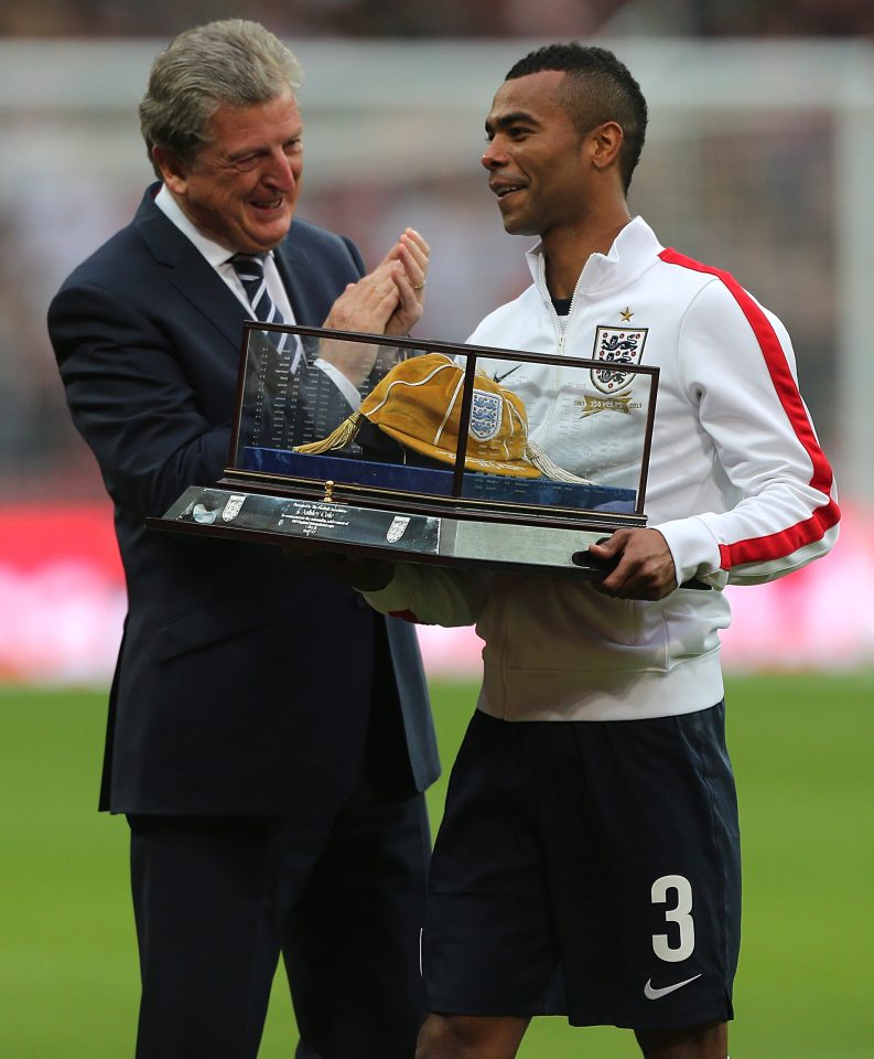 England's Ashley Cole (right) is presented with his 100th cap