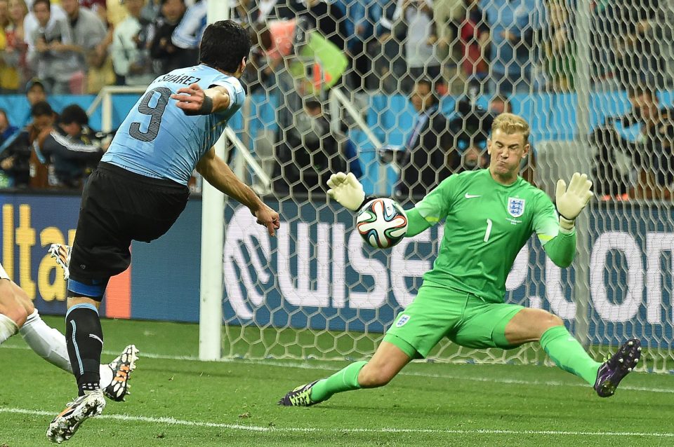 Uruguay's forward Luis Suarez (L) scores against England'