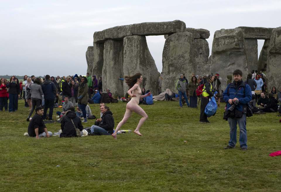 A naked reveller celebrates the summer solstice at Stonehenge on June 21, 2015