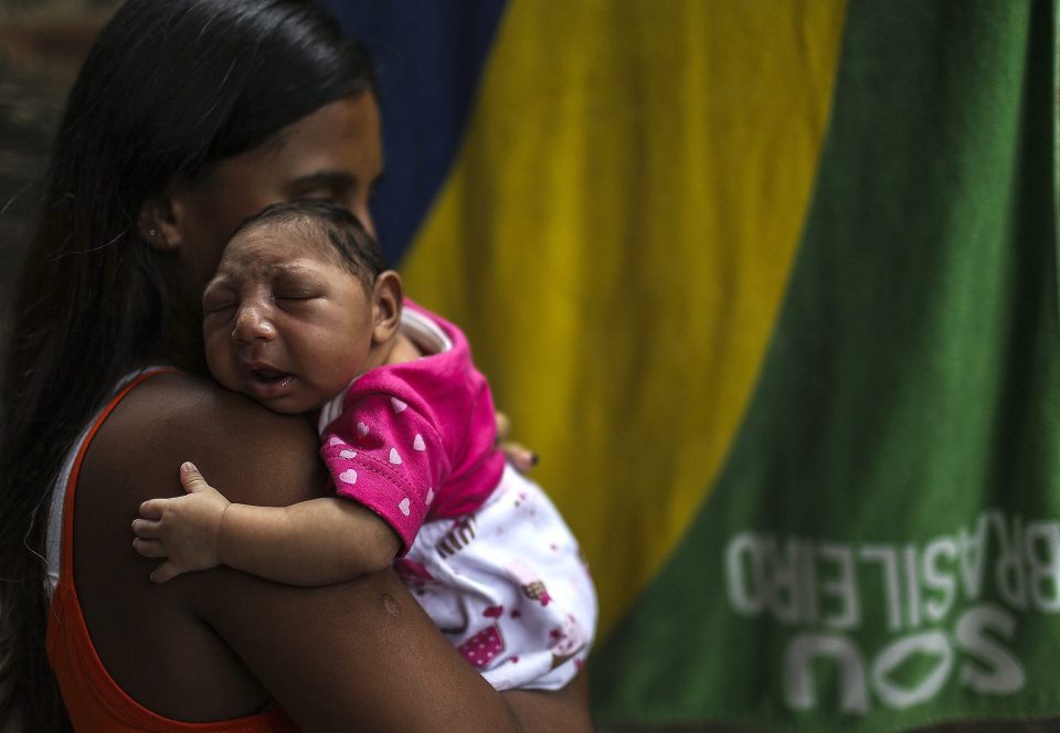Leticia de Araujo (L) holding her daughter