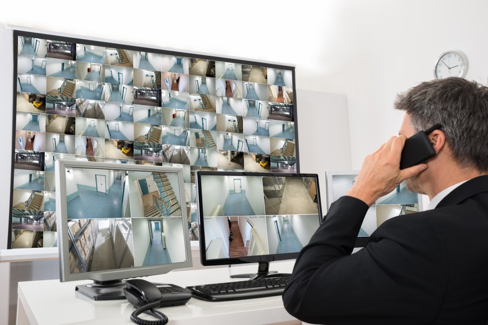 Security operator looks at monitors