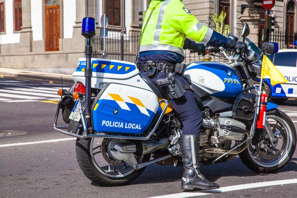 local police officer on motorbike riding the streets of Santa Cruz de Tenerife city. Image shot 2015. Exact date unknown.