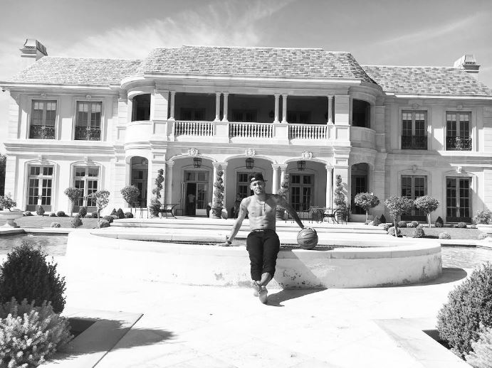 Neymar poses outside the £7,097-a-night Beverly Hills mega-mansion he spent the weekend in