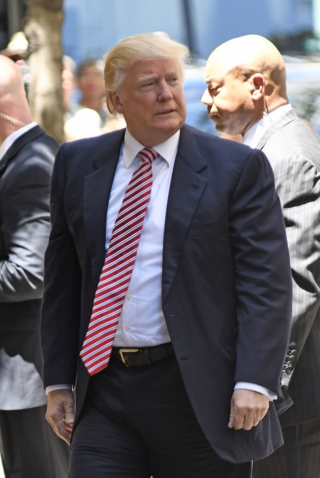 Donald Trump waves to the crowd as he arrives at the Four Seasons Hotel in New York City