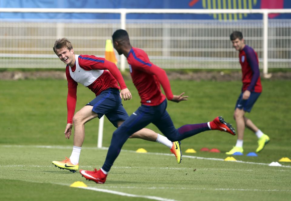 Eric Dier and Marcus Rashford joke as they race each other in England training