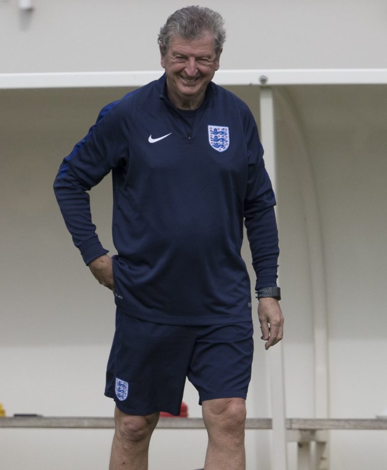 Roy Hodgson reaches into his pocket as he smiles at the photographers