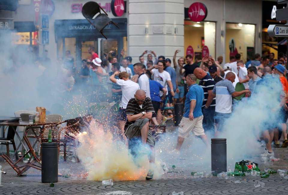 A teargas grenade explodes near an England fan ahead of England's EURO 2016 match in Marseille
