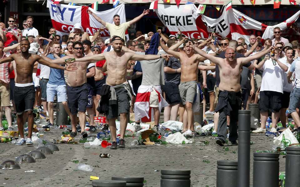 Topless England fans taunt Russian supporters at the port of Marseille before the game