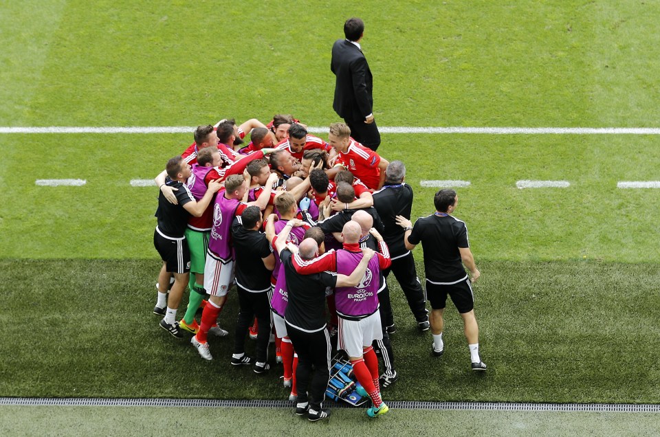 Wales's Gareth Bale, covered by his teammates, celebrates after scoring during the Euro 2016 Group B soccer match between Wales and Slovakia, at the Nouveau stadium in Bordeaux, France, Saturday, June 11, 2016. (AP Photo/Hassan Ammar)