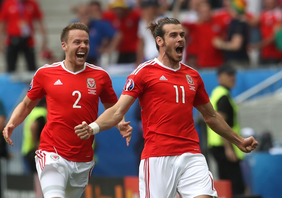 Wales's Gareth Bale celebrates after scoring the opening goal during the Euro 2016 Group B soccer match between Wales and Slovakia, at the Nouveau stadium in Bordeaux, France, Saturday, June 11, 2016. (AP Photo/Petr David Josek)