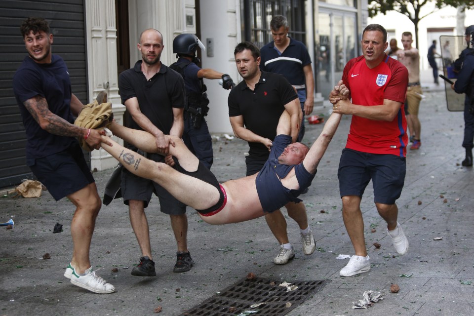This England fan was carried to safety by his pals after being beaten unconscious