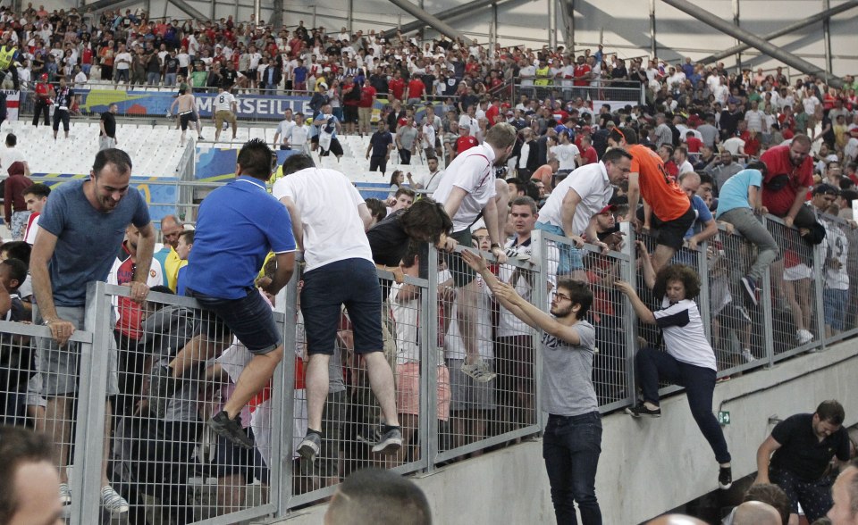 England fans climb fences in a desperate effort to escape the violence