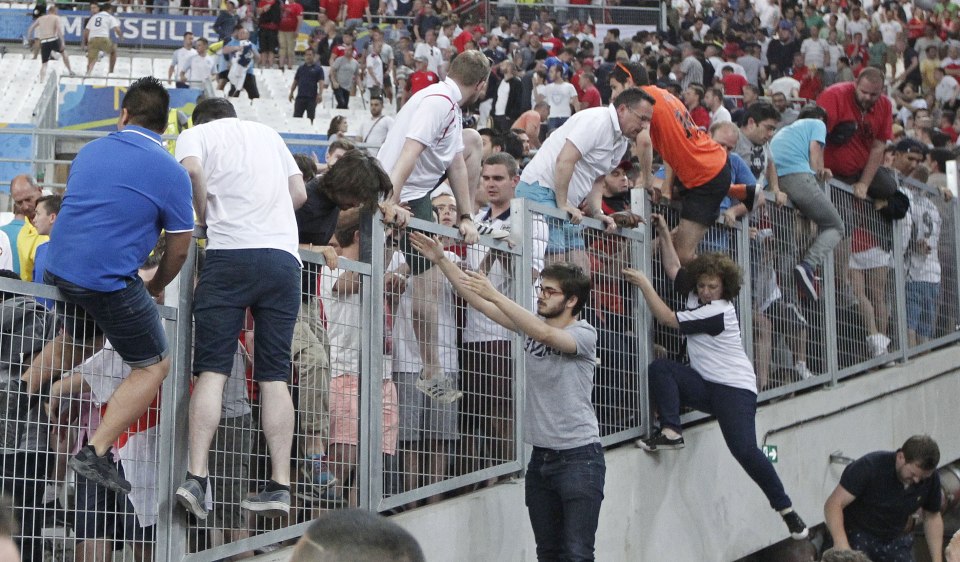 Spectators try to escape from Russian supporters who went on a charge in the stands right after the Euro 2016 Group B soccer match between England and Russia, at the Velodrome stadium in Marseille, France, Saturday, June 11, 2016. (AP Photo/Thanassis Stavrakis)
