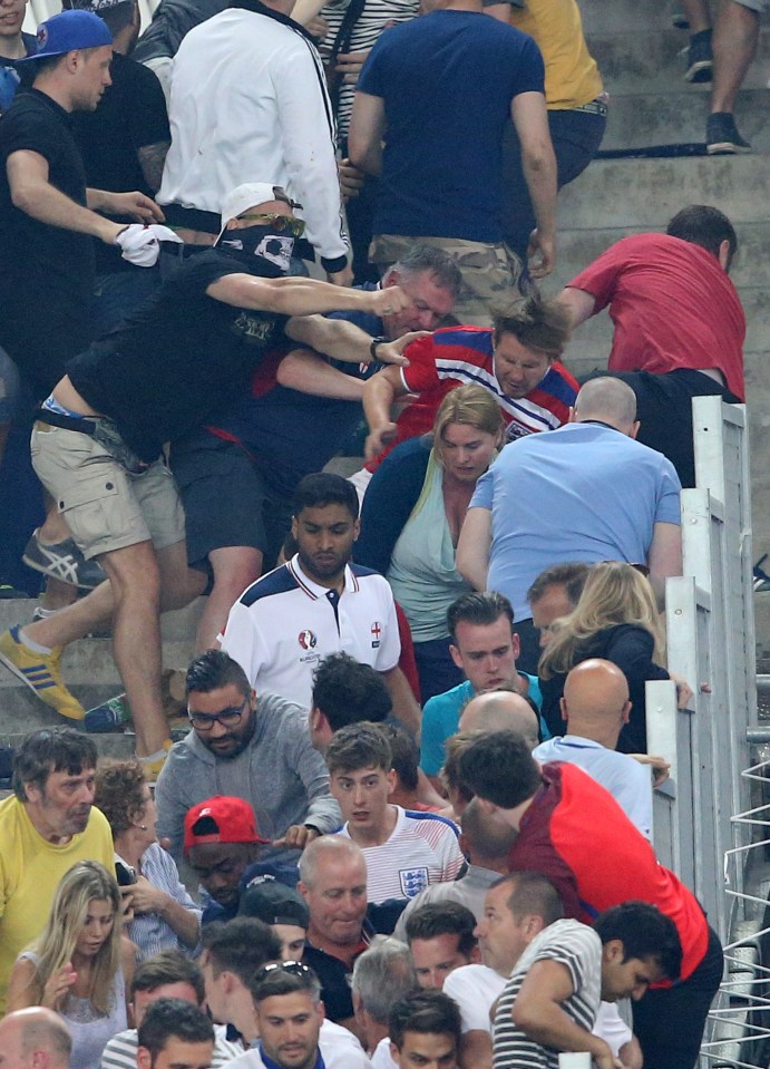 Masked Russian hooligan punches England fan as rival supporters clash