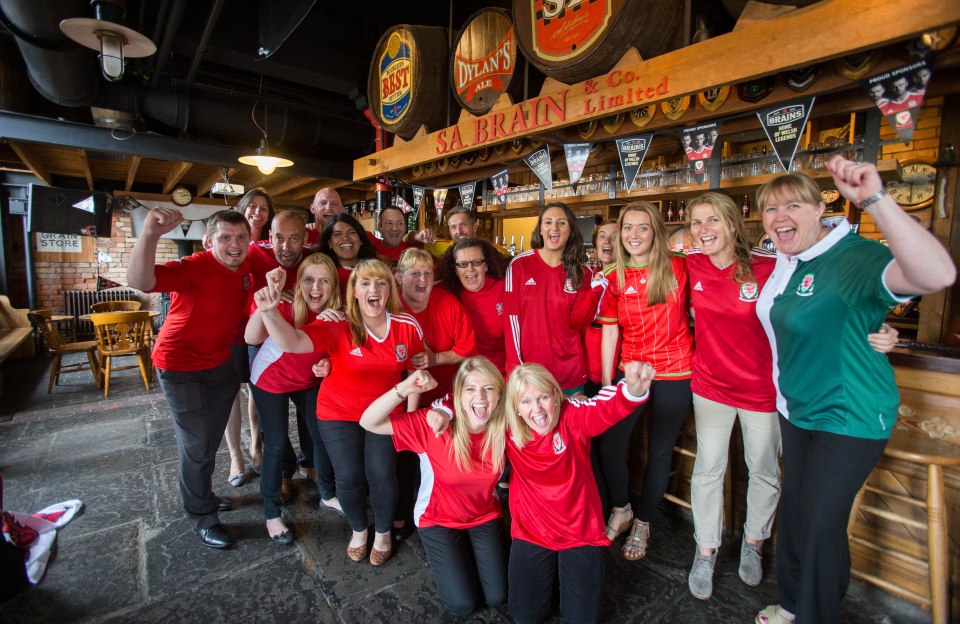 Staff at the Brains Brewery in Wales donned their nation's red strip to help raise money for bowel cancer ahead of the England clash today