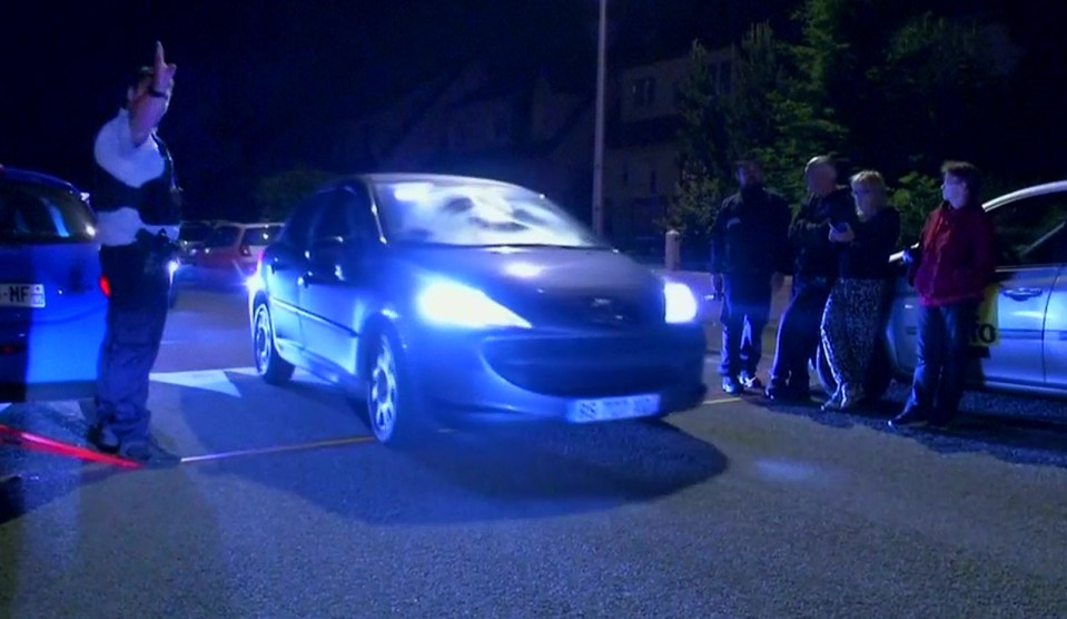 Still image taken from video shows Police vehicles at the scene near where a French police commander was stabbed to death in front of his home