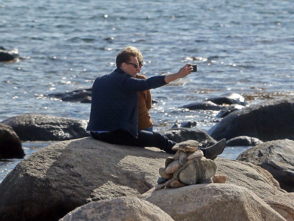 Tom Hiddlestone takes the lead as he captures a special moment of himself and new love Taylor Swift on his phone 