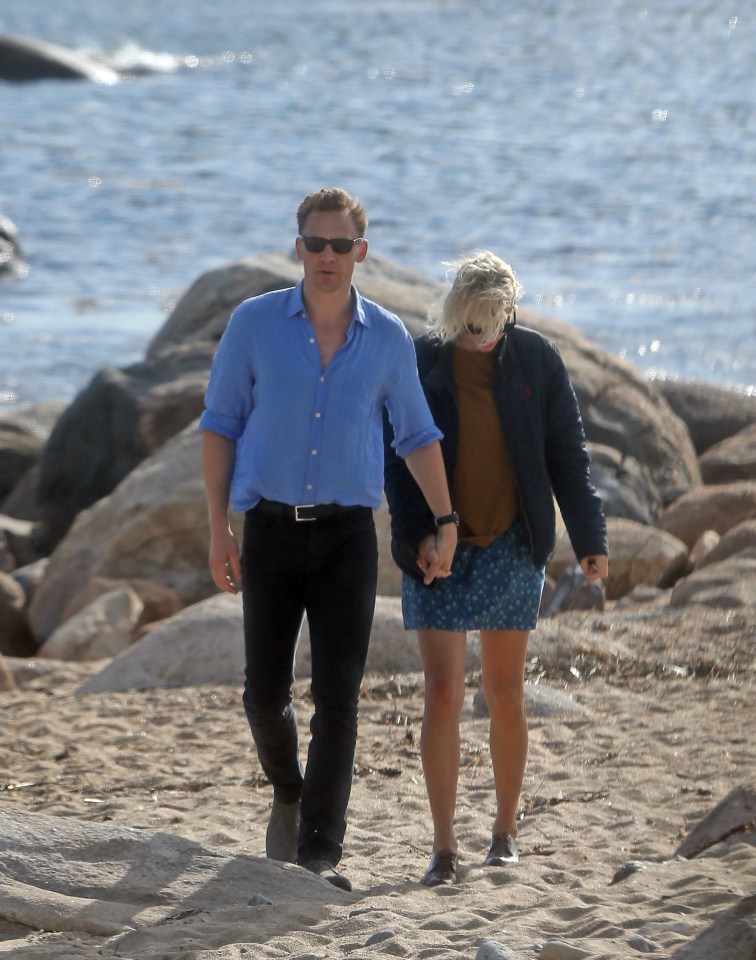 Taylor Swift and Tom Hiddlestone hold hands as they enjoy a romantic stroll across one of Taylor's favourite beaches in Rhode Island 