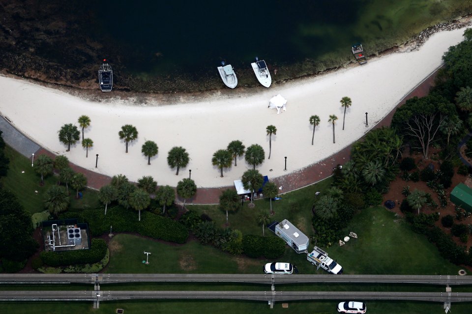 Rescue boats, tents and police vehicles are seen along the shoreline at the Grand Floridian