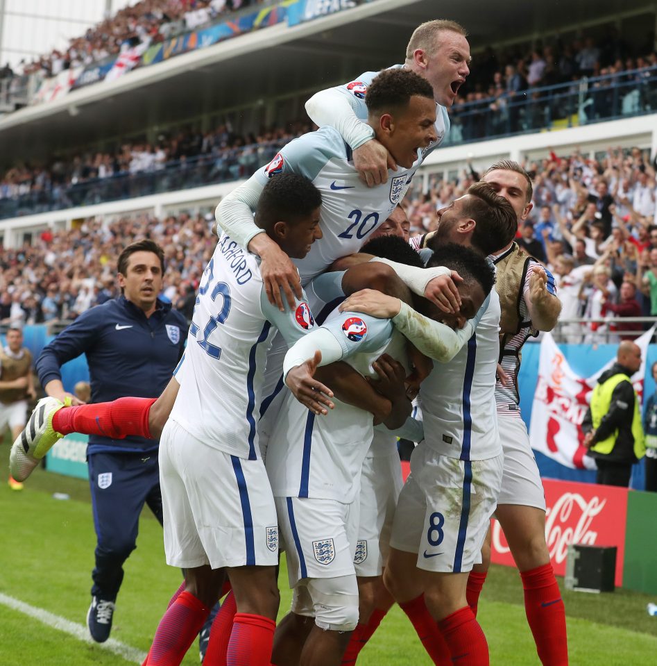 England coach Neville races to celebrate with the side after Daniel Sturridge struck in stoppage time to snatch a late win over Wales