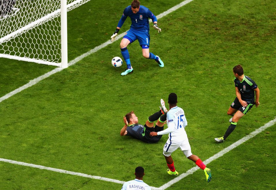 Sturridge watches his shot squeeze past Wayne Hennessey in the Wales goal