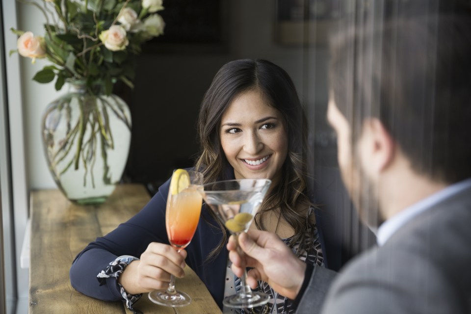 Couple enjoying cocktails at bar