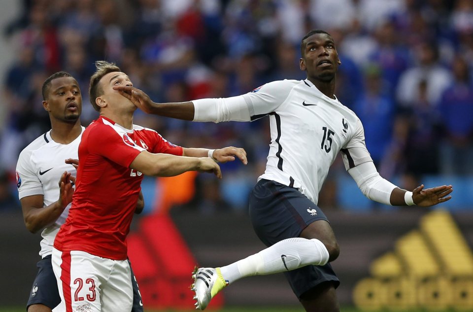 Xherdan Shaqiri challenges France midfielder Paul Pogba for the ball