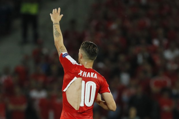 Granit Xhaka's shirt is torn during Switzerland's Euro 2016 Group A game with France in Lille