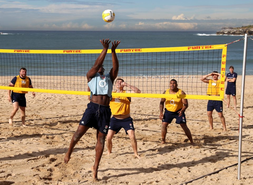 Maro Itoje smashes the ball during a game of beach volleyball