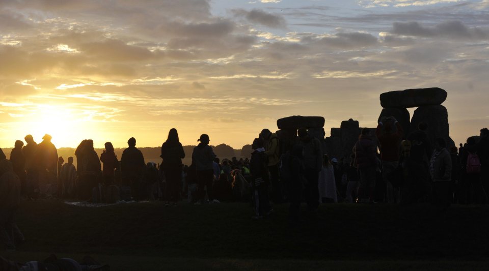 People gather to watch the sunrise on the longest day of the year