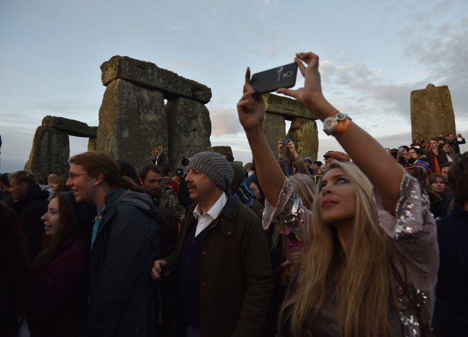 Selfie love... a woman snaps an image during the solstice sunset
