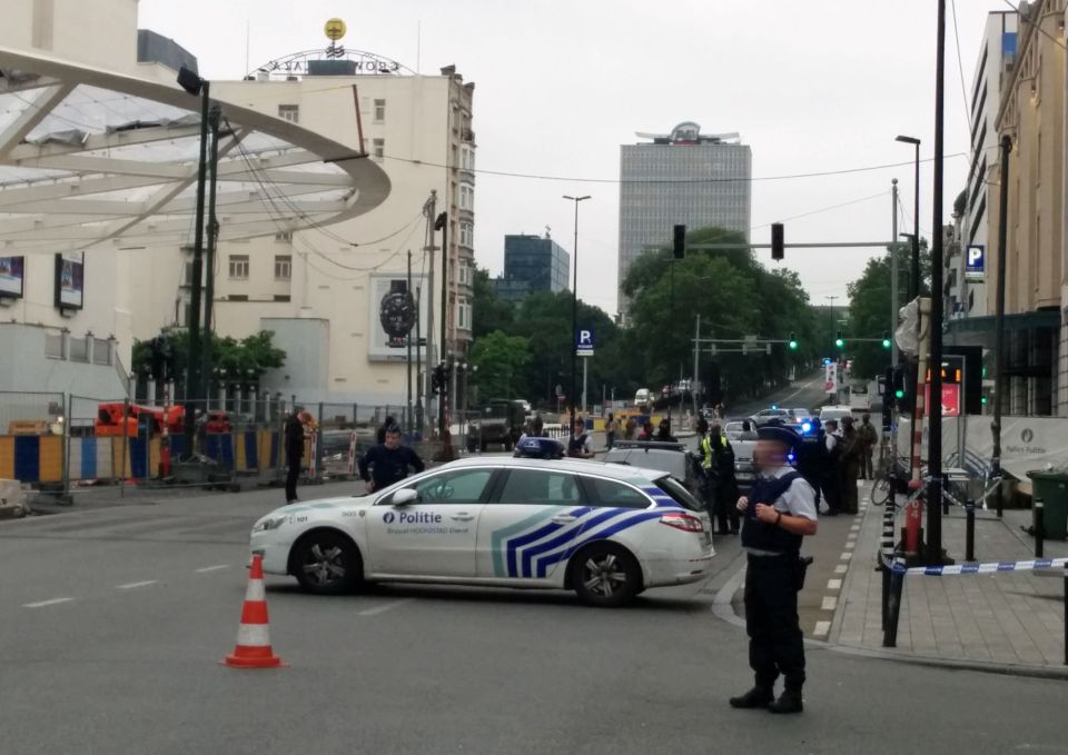 Police cars block the area as police off