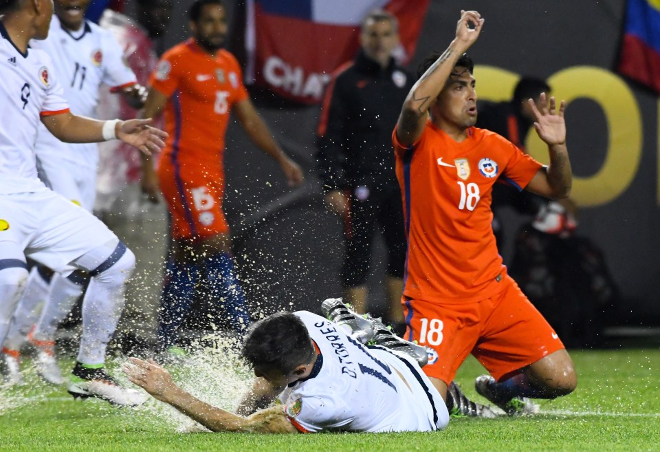 Jun 22, 2016; Chicago, IL, USA; Colombia midfielder Daniel Torres (16) is fouled by Chile defender Gonzalo Jara (18) during the second half in the semifinals of the 2016 Copa America Centenario soccer tournament at Soldier Field. Chile defeated Colombia 2-0. Mandatory Credit: Mike DiNovo-USA TODAY Sports