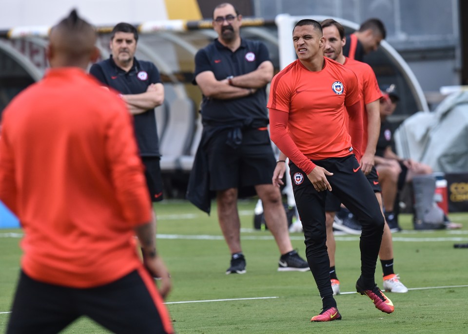 Chile's Alexis Sanchez grimaces in pain during a training session