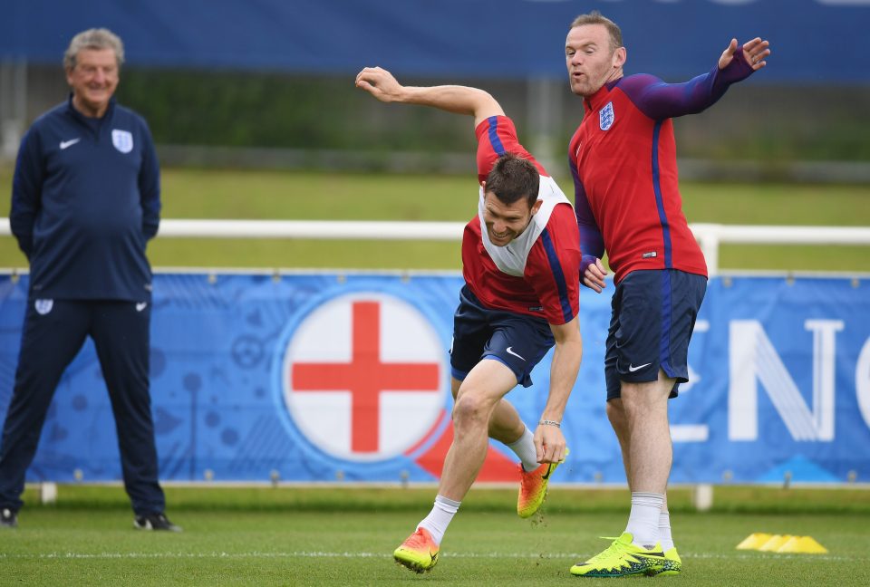 Wayne Rooney and James Milner take avoiding action as England manager Roy Hodgson looks on in training at Chantilly
