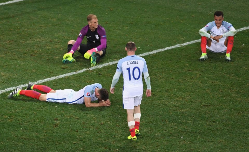 Wayne Rooney (2nd R) of England walks to console Gary Cahill (1st L), Joe Hart (2nd L) and Dele Alli