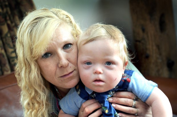 Kirsty Graves, and baby Reggie. North Trade Road, Battle. A mum has slammed emergency services after she rang 999 when her baby was choking - and she was put on HOLD. See story NNCHOKE. Kirsty Graves called the ambulance services after her 13-month old son Reggie Breach, who has Downs Syndrome, started joking on a piece of plastic. But after choosing her required emergency service, Kirsty couldn't believe it when she was put on hold for several minutes - that she said seemed like an eternity. The South East Coast Ambulance Service were forced to apologise for the shocking incident. The mum-of-four said: "I have never heard of anyone being put on hold on 999 before, ever. "I'm not the sort of person who panics easily. "But when I was put on hold, I started to panic. "By that time he was blue and was not breathing." Kirsty, from Battle, East Sussex, said she was on hold for a few minutes - but that it felt like an eternity. *** Local Caption *** Byline - Hastings Observer/ SWNS.com