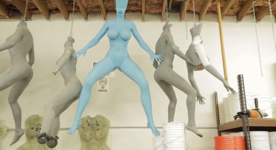 One shot shows a row of dangling bodies, before any identifying features have been added to the rubbery pleasure aids