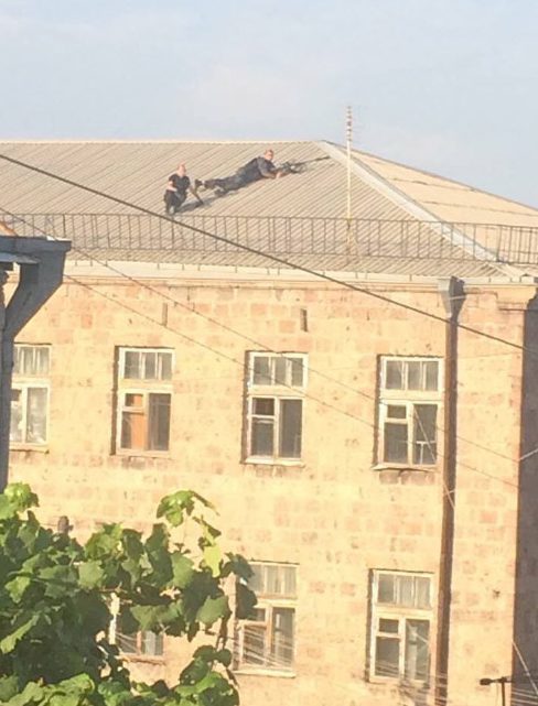 Snipers pictured on the roof, while Armenia National Security Service claims 'peaceful' negotiations are underway