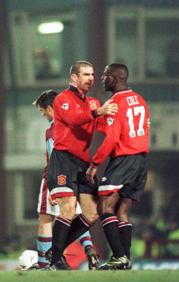 22 Jan 1996: Striker Eric Cantona of Manchester United holds back teammate Andy Cole after clashing with a referee during the Manchester United FA Premiership match against West Ham United at Upton Park in London. Mandatory Credit: Shaun Botterill/Allsport