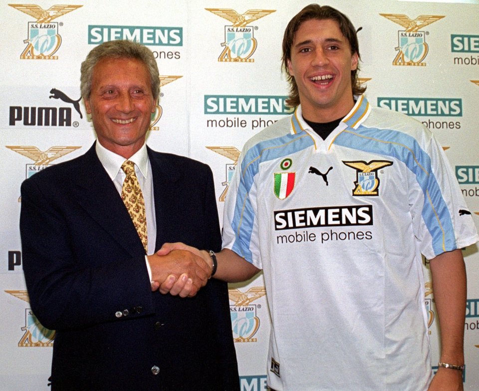 Argentina's Hernan Crespo, right, wearing his perspective team Lazio's jersey, shakes hands with Lazio's president Sergio Cragnotti during his official presentation at team's headquarters in Formello, in the outskirts of Rome, Monday, July 31, 2000. Crespo, coming from Italian team Parma, will play for Lazio next season. (AP Photo/Giuseppe Calzuola)