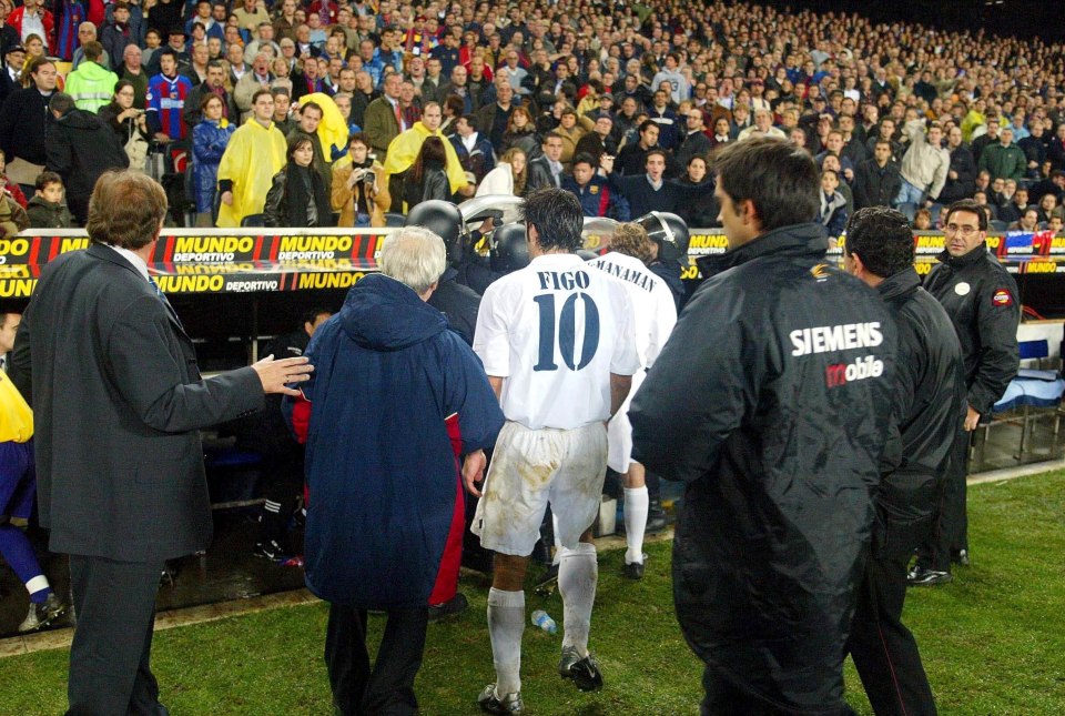 BARCELONA - NOVEMBER 23: Luis Figo of Real Madrid leaves the pitch as play was suspended during the La Liga match between FC Barcelona and Real Madrid played at the Nou Camp Stadium, Barcelona, Spain on November 23, 2002. (Photo by Firo Foto/Getty Images)