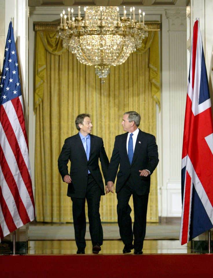 President George W Bush and British Prime Minister Tony Blair (L) arrive for a joint press conference in the White House July 17, 2003. The two leaders, dogged by questions about their justification for invading Iraq, met to reinforce their special relationship which has been strained by postwar chaos and intelligence failures. REUTERS/Kevin Lamarque