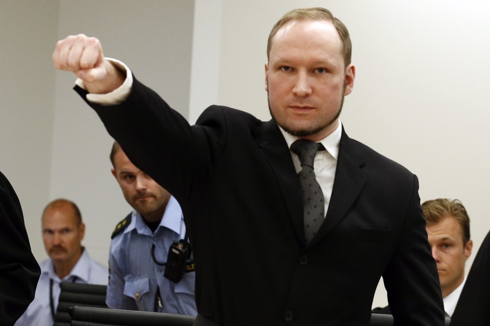 Mass murderer Anders Behring Breivik, makes a salute after arrives at the court room in Oslo Friday Aug. 24, 2012 Breivik was convicted Friday of terrorism and premeditated murder for bomb and gun attacks that killed 77 people and sentenced to a special prison term that would allow authorities to keep him locked up for as long as he is considered dangerous. (AP Photo/Heiko Junge / NTB scanpix, Pool)