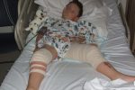 seven year old Christian Hickey in his hospital bed after gunmen blasted the schoolboy and his mother on their doorstep
