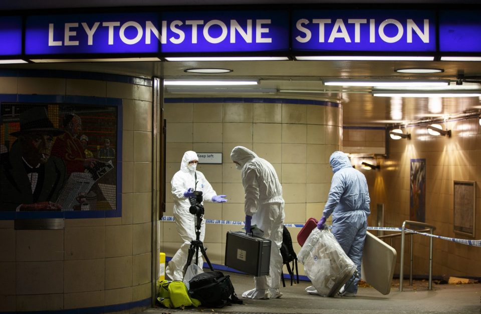 Police officers and crime scene investigators pictured at Leytonstone Tube station in east London, England, on December 5 last year