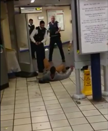 Cops stand over Mire after Tasering him - before they cuff him for attempted murder